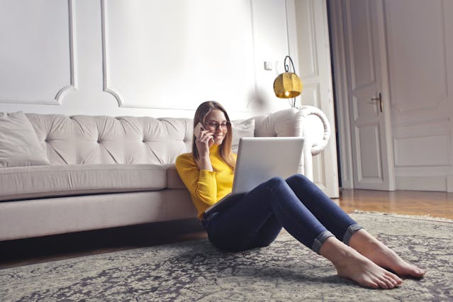 Young lady looking at a screen wearing blue light glasses